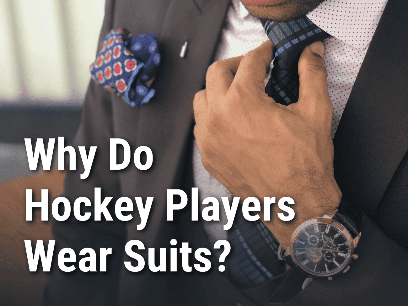 Why do hockey players wear suits? Man in suit and tie.